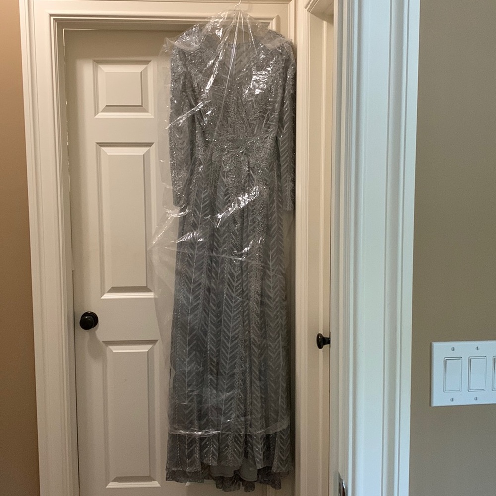 Never worn (purchased a month ago) silver sequined Mac Duggal ball gown. Size 10